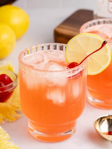 The Masters Azalea Cocktail with a cherry and lemon slice for garnish