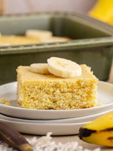 Banana Cornbread on a plate with slices of banana on top