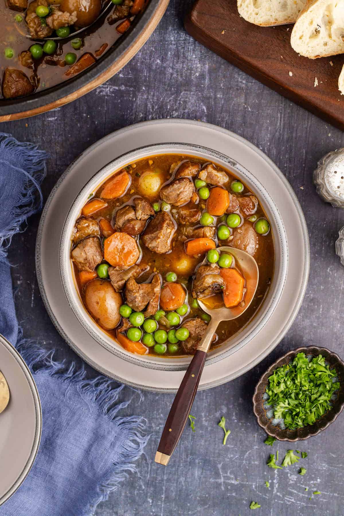 Guinness Lamb Stew in a bowl with food on a spoon from above