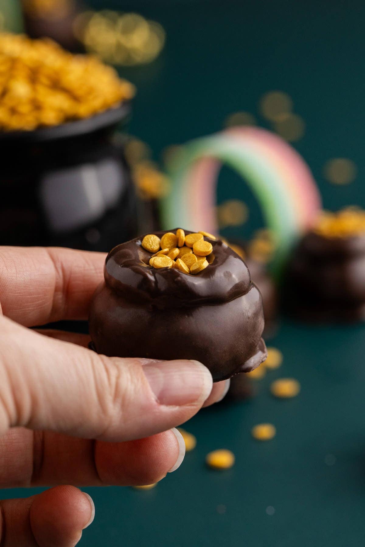 Mint Truffles with gold coin sprinkles being picked up