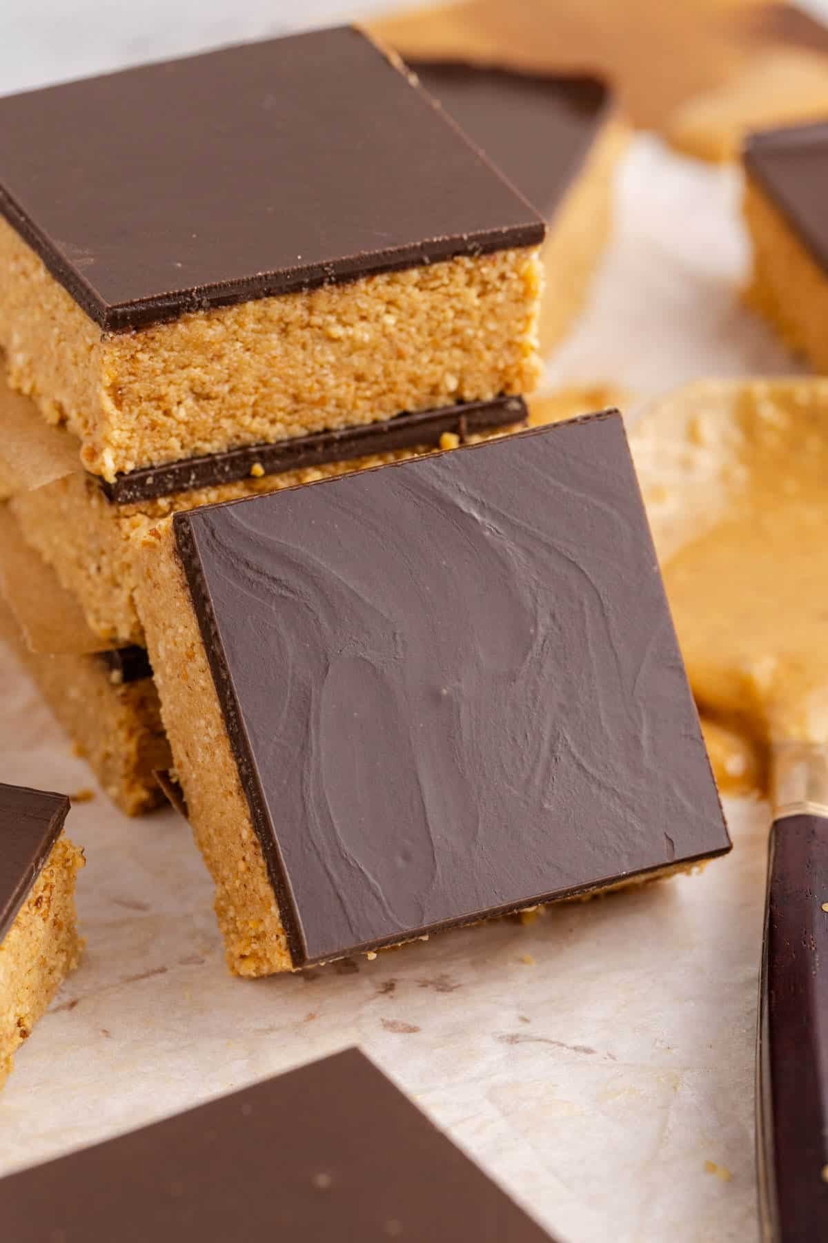 No Bake Peanut Butter Bars stack with one leaning up against it