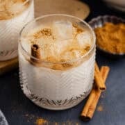 Agua de Horchata in a glass with ground cinnamon on top