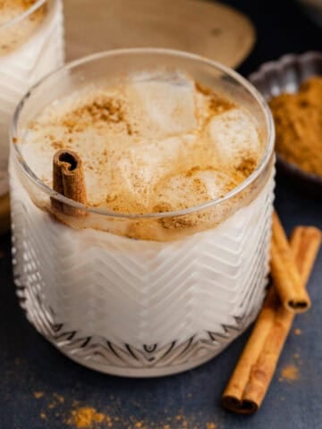 Agua de Horchata in a glass with ground cinnamon on top
