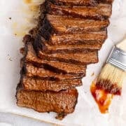 Brisket sliced from above with a basting brush and sauce