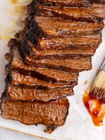 Brisket sliced from above with a basting brush and sauce