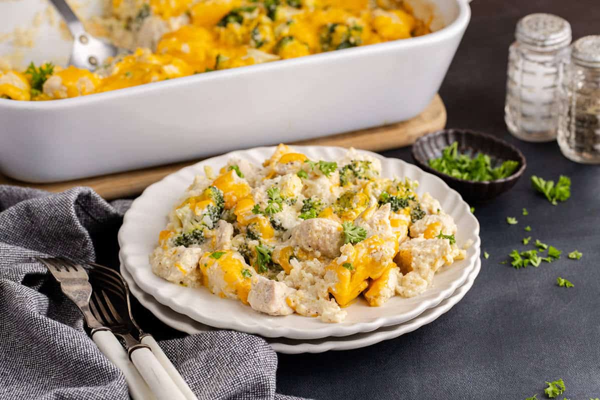 Chicken Broccoli Casserole with Rice on a plate with a baking dish in the back