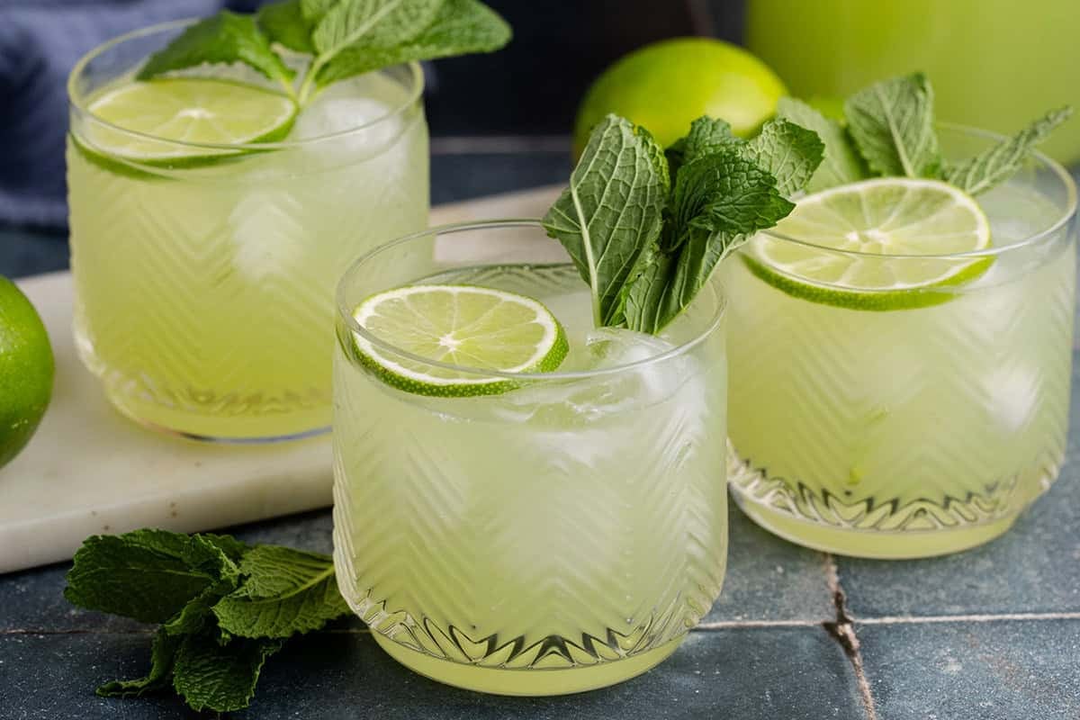 Cucumber Agua Fresca on a counter with limes and mint