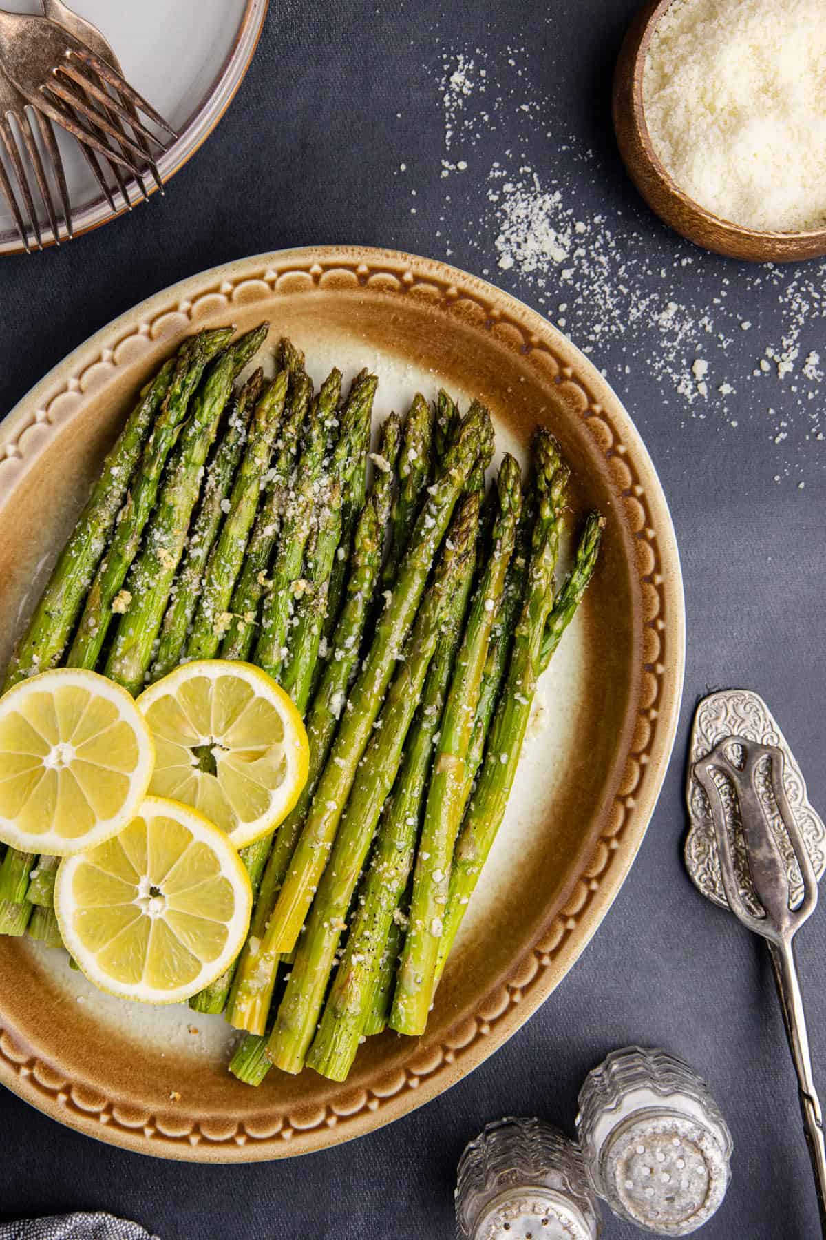 Garlic Parmesan Asparagus on a platter from above with lemon slices