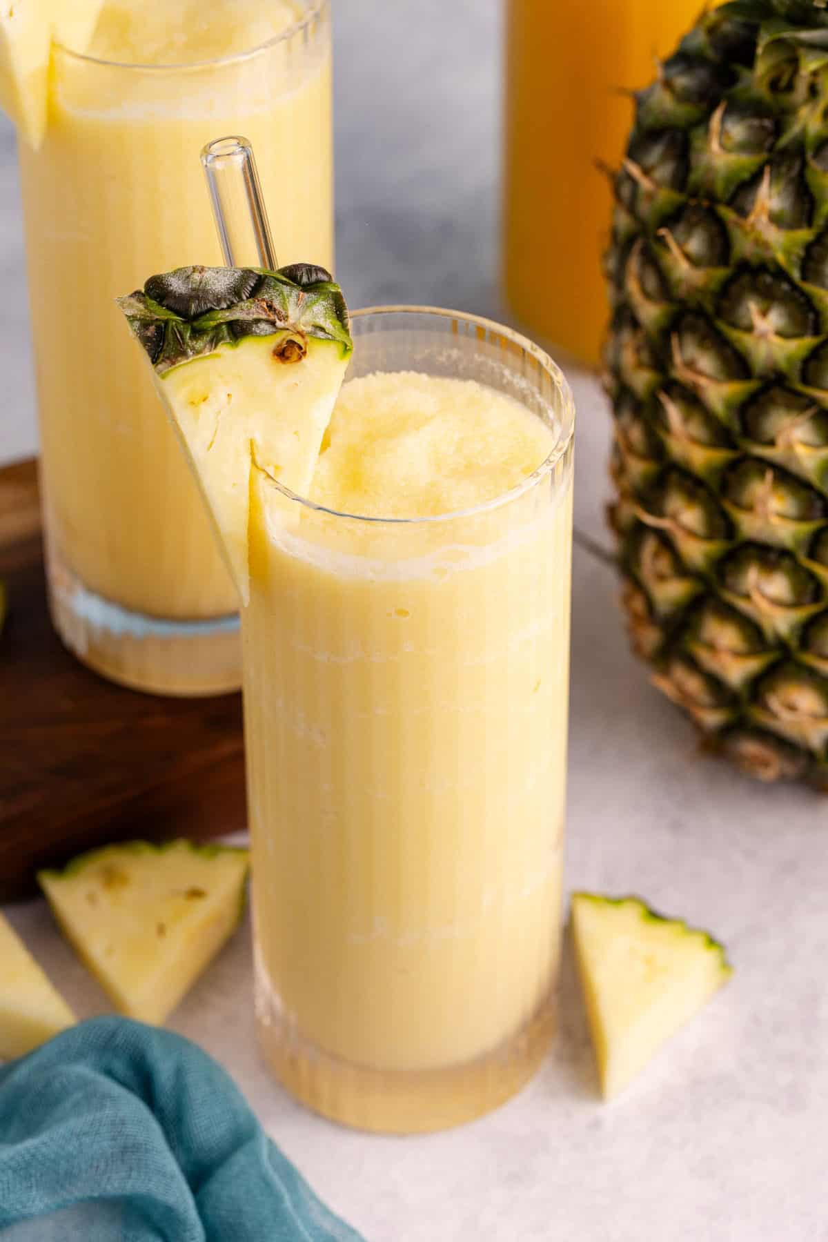 A glass of non-alcoholic Pina coladas with pineapple garnish