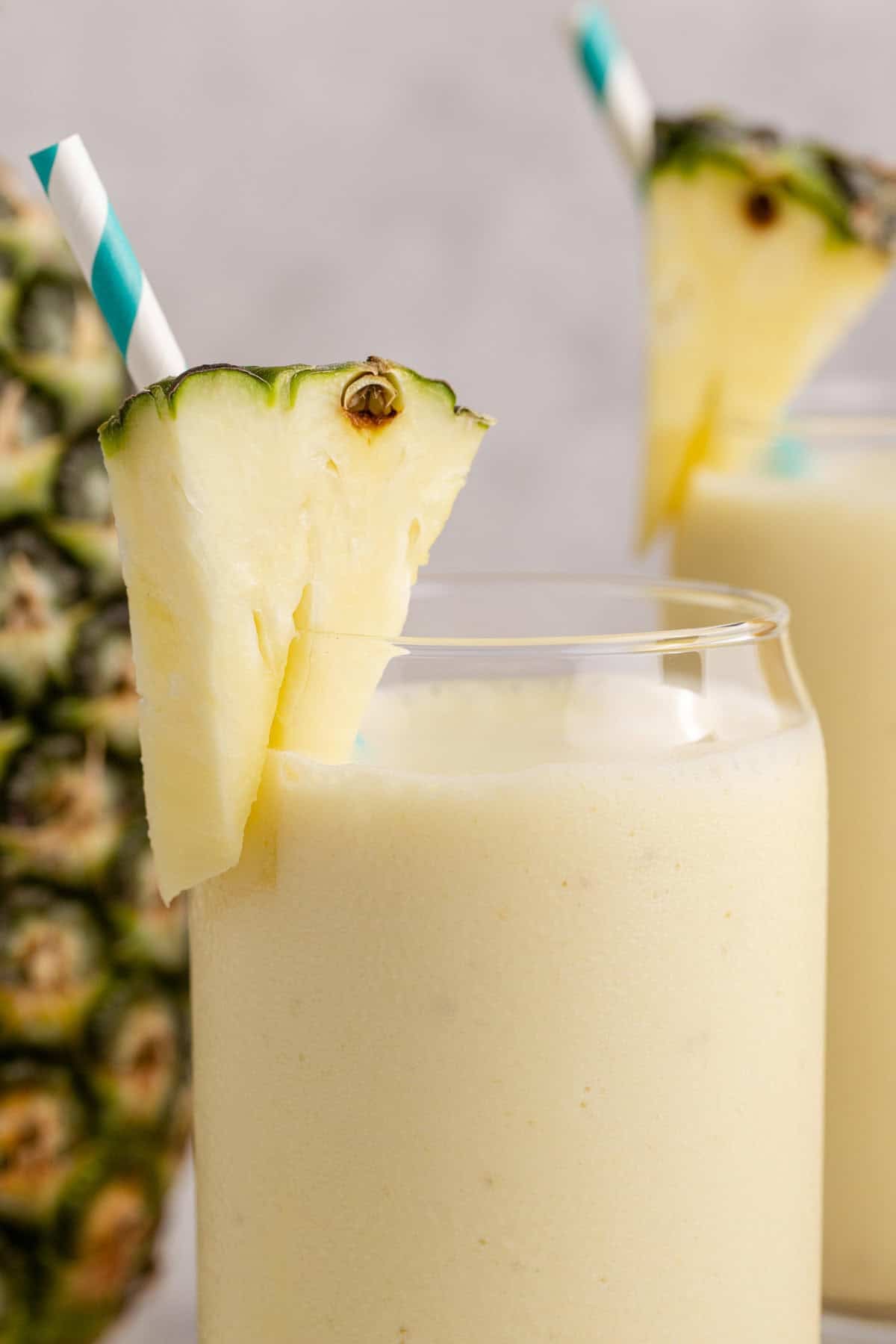 Close up of a Pineapple Banana Smoothie with Coconut Milk with a pineapple garnish
