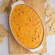 Spicy Sausage Queso in an oval dish from above with corn chips all around
