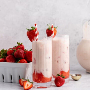 Strawberry Horchata on a counter with a basket of berries