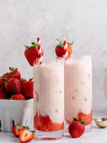 Strawberry Horchata on a counter with a basket of berries