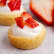 Strawberry Shortcake Cookie Cups up close with strawberries in the back