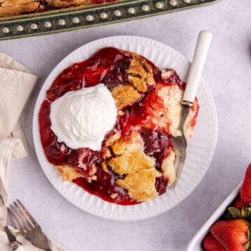 Strawberry Dump Cake from above with a fork and ice cream on the plate