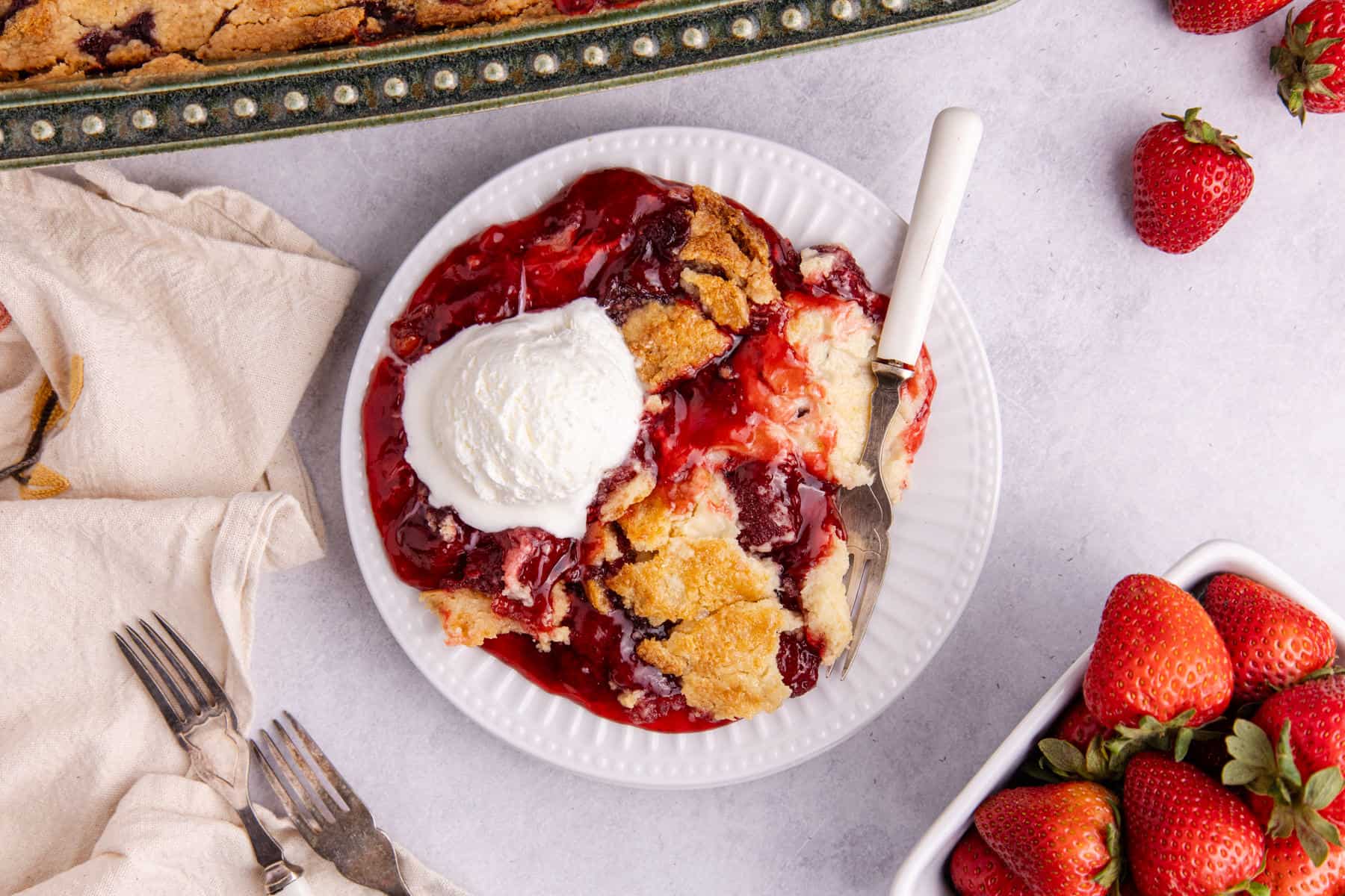 Strawberry Dump Cake from above with a fork on the plate
