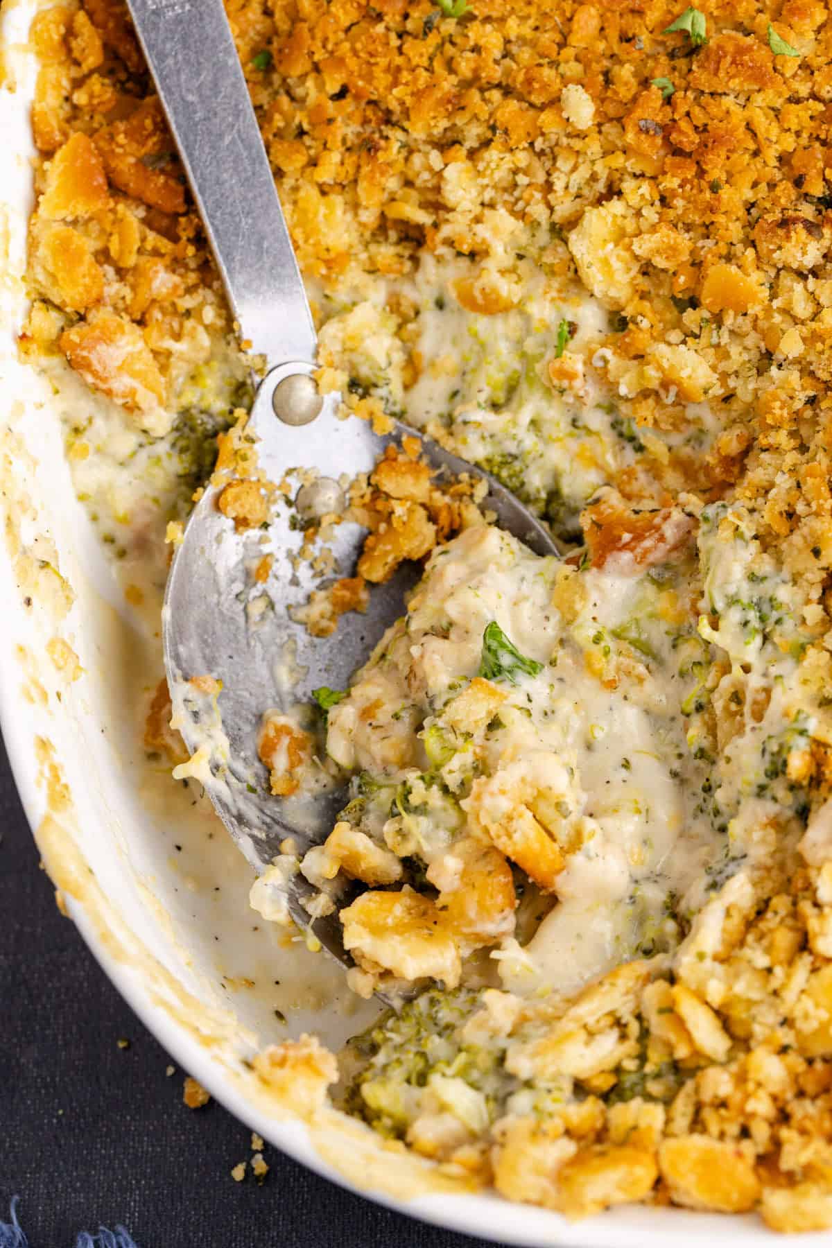 broccoli casserole with Ritz dish from above with a spoonful being taken