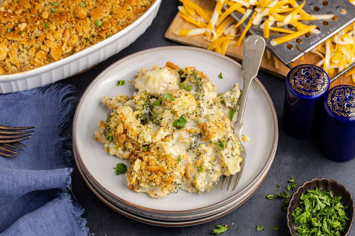 broccoli casserole with Ritz on a plate with cheese in the back