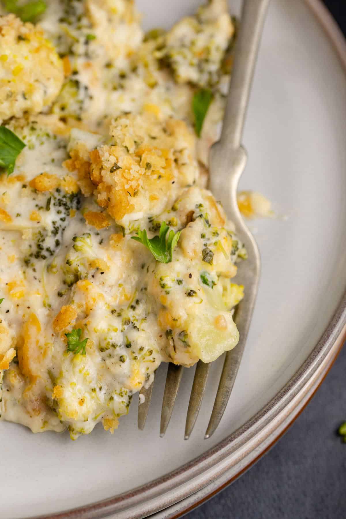 broccoli casserole with Ritz up close on a plate under a fork