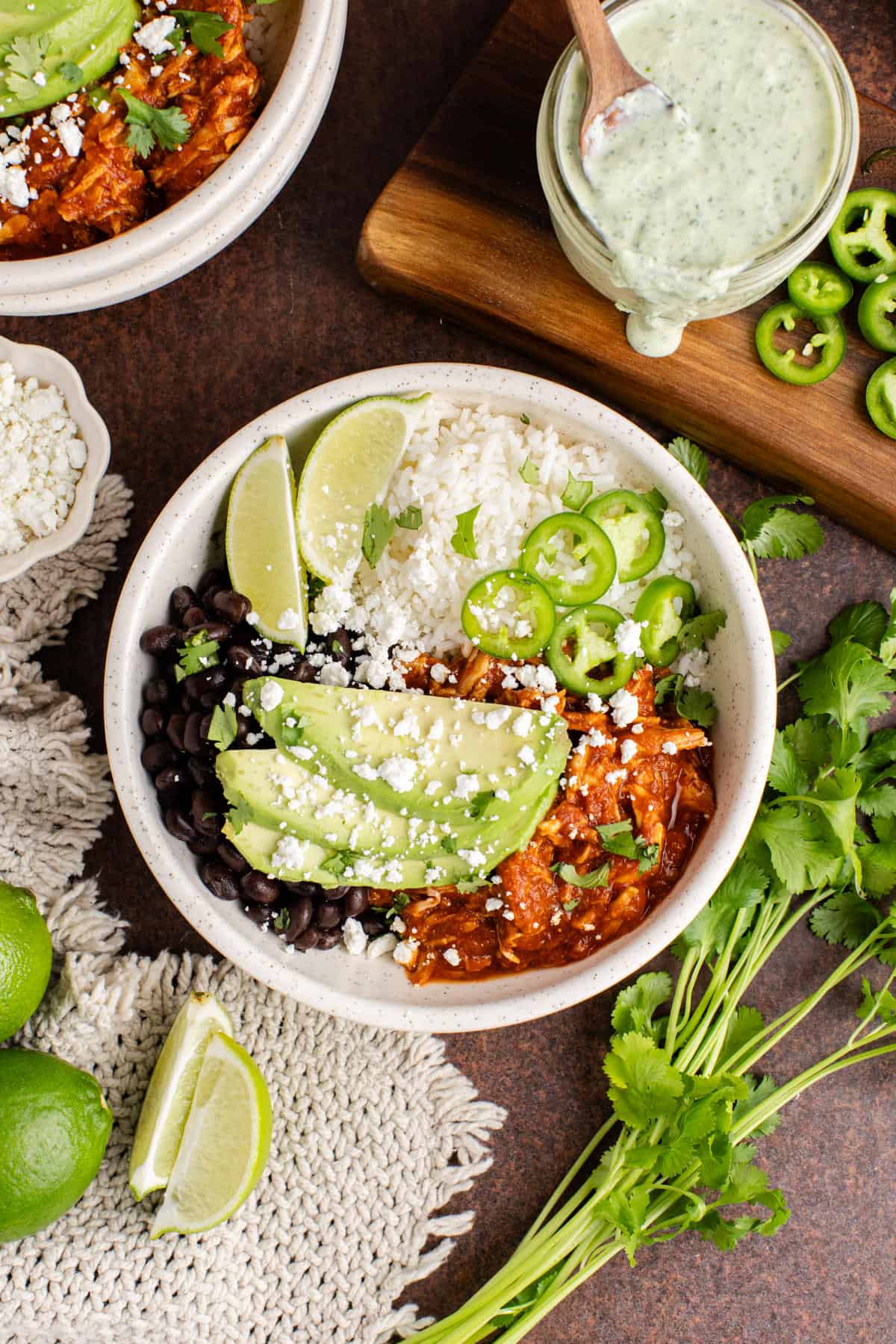 Chicken Tinga bowl from above garnished with cilantro, avocado and jalapeños