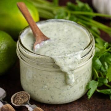 Cilantro Lime Dressing in a jar with a spoonful running down the front