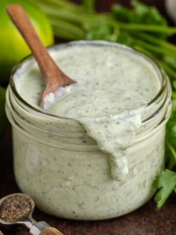 Cilantro Lime Dressing in a jar with a spoonful running down the front