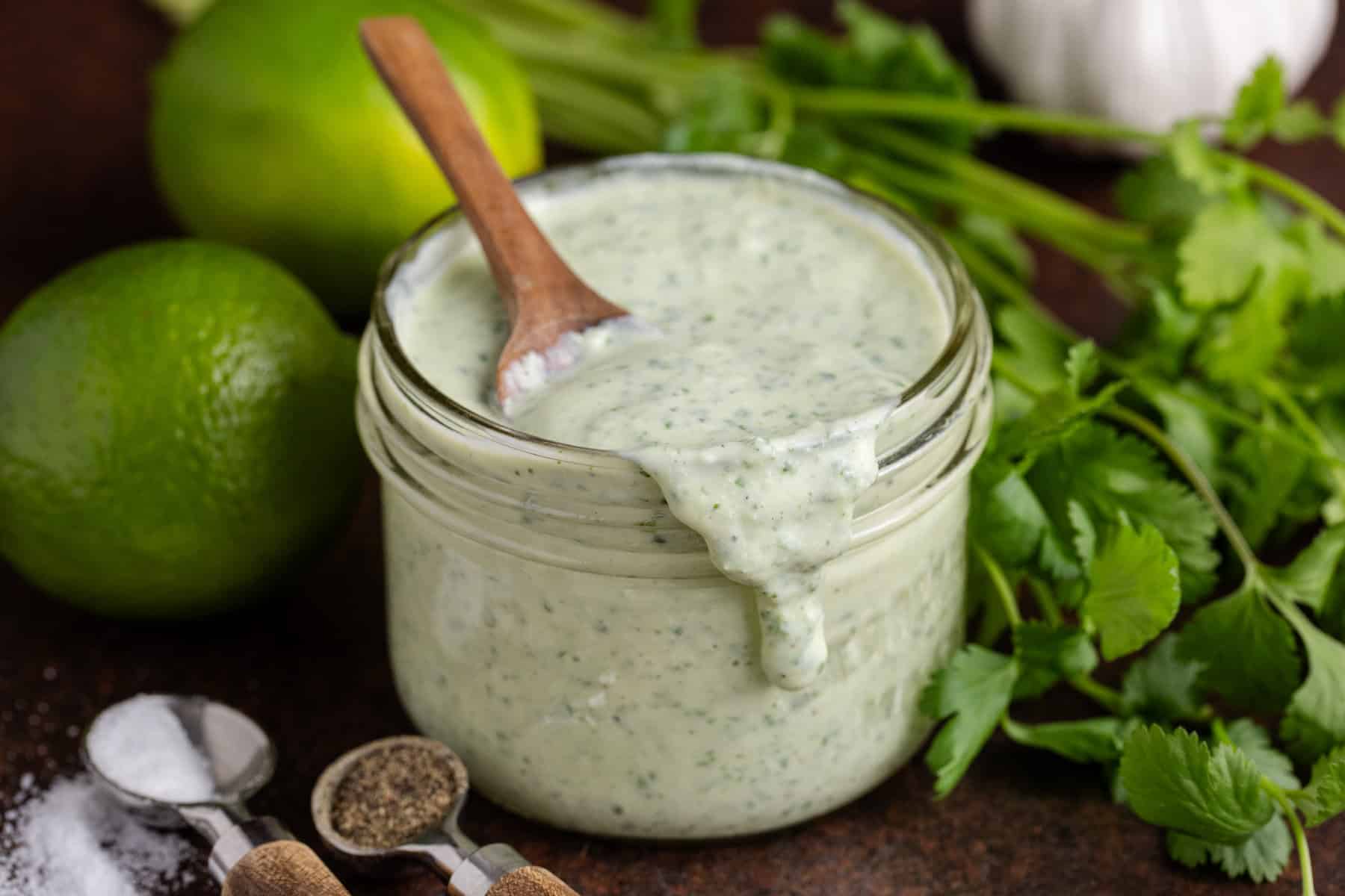 Cilantro Lime Dressing in a jar with a spoonful running down the front