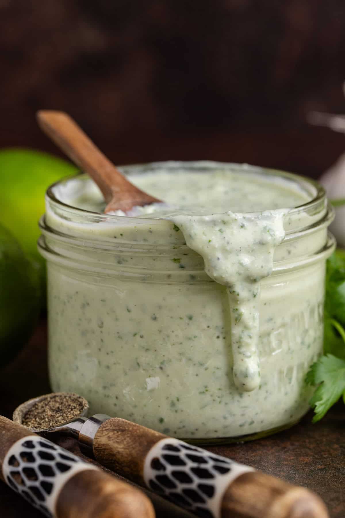 Cilantro Lime Dressing in a jar with a spoonful running down the front