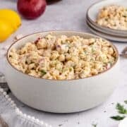 Cold Tuna Pasta Salad in a serving bowl with a plateful in the back