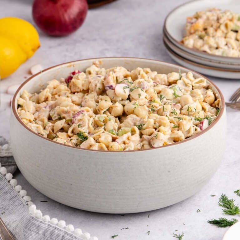 Cold Tuna Pasta Salad in a serving bowl with a plateful in the back