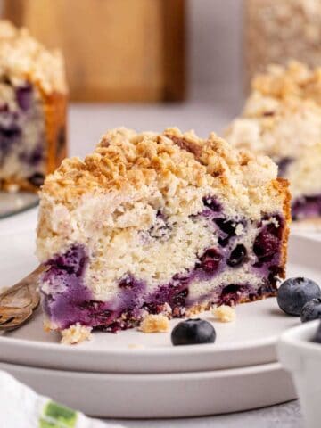 Blueberry Coffee Cake on plates with fresh blueberries