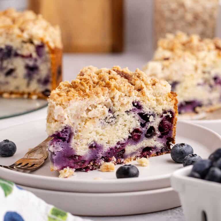 Blueberry Coffee Cake on plates with fresh blueberries