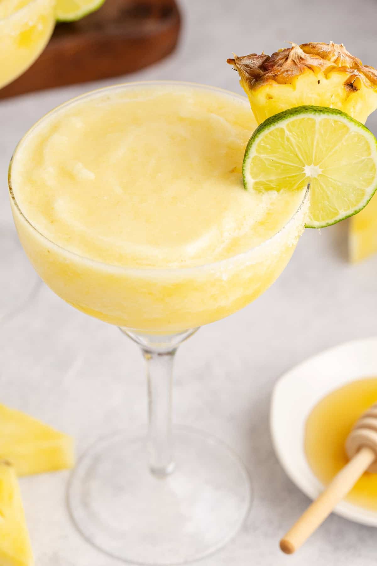 Frozen Non Alcoholic Pineapple Margarita up close with honey beside