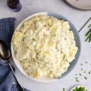 Potato Salad without Eggs in a serving bowl with chives on top