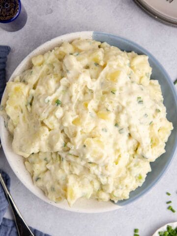 Potato Salad without Eggs in a serving bowl with chives on top