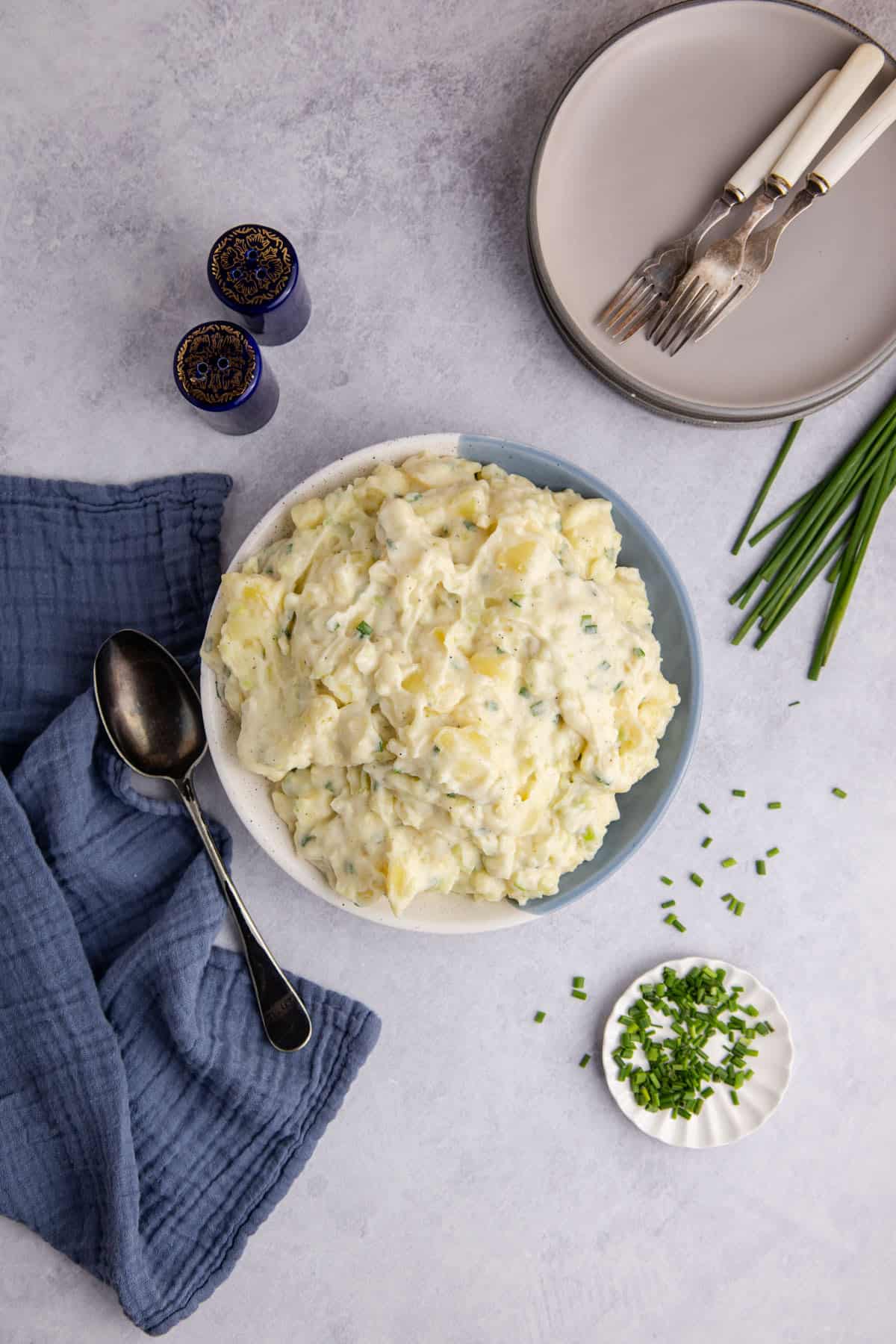 Potato Salad without Eggs in a serving bowl with chives on top