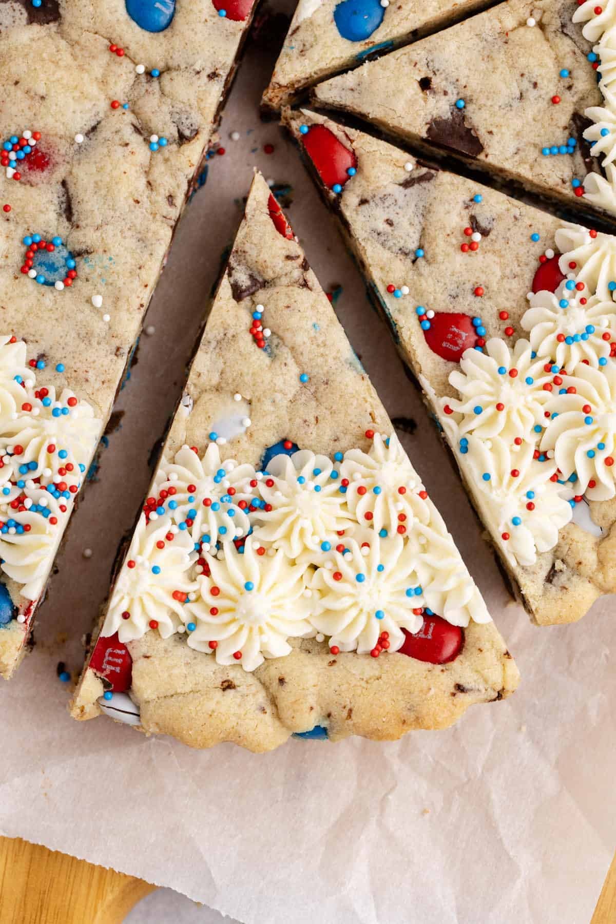 A close up of a slice of a Red White and Blue Cookie Cake