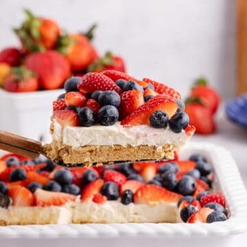 Red, White and Blue Pretzel Salad being lift from baking dish
