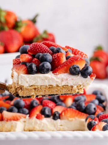 Red, White and Blue Pretzel Salad being lift from baking dish