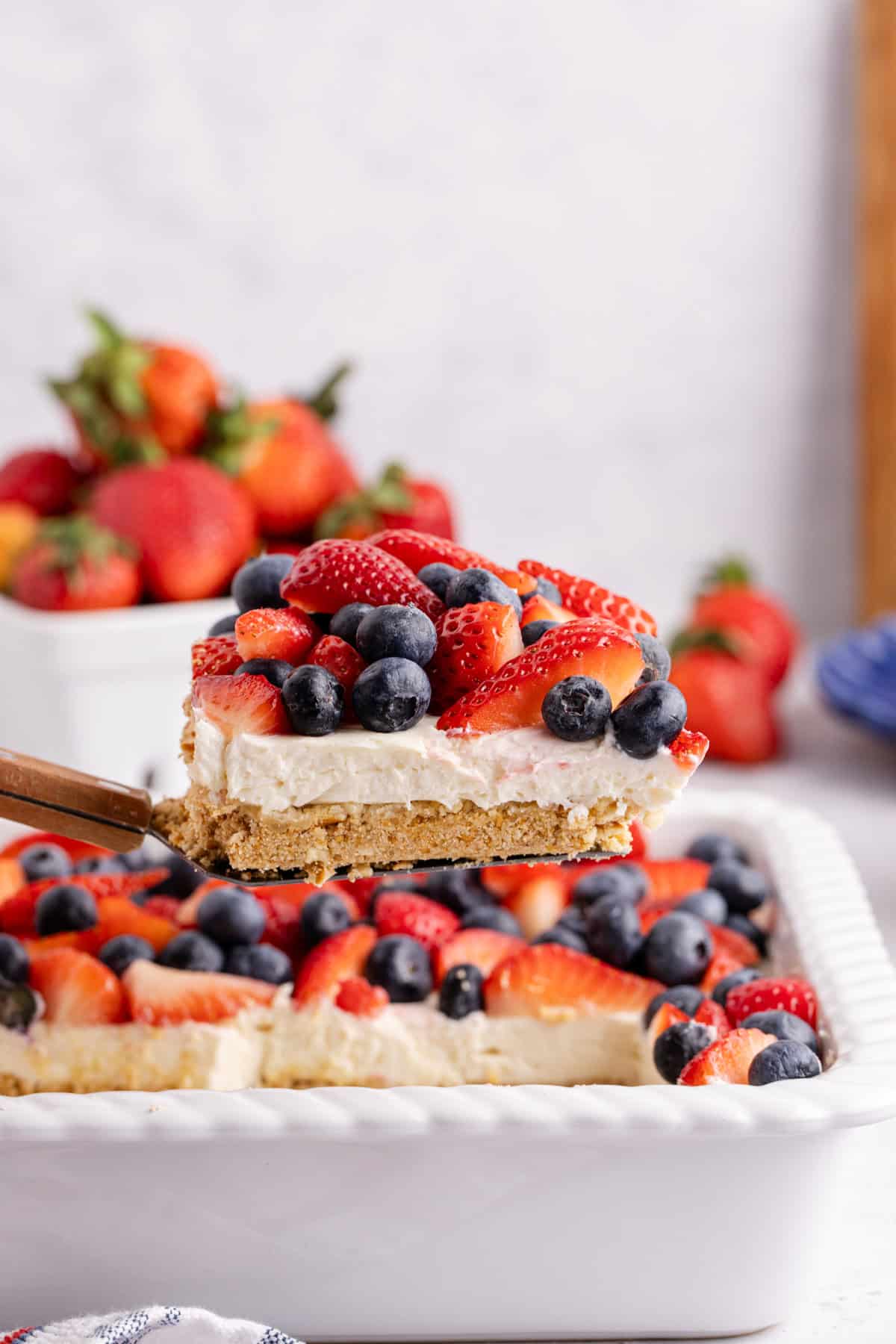 Red, White and Blue Pretzel Salad being lift from baking dish