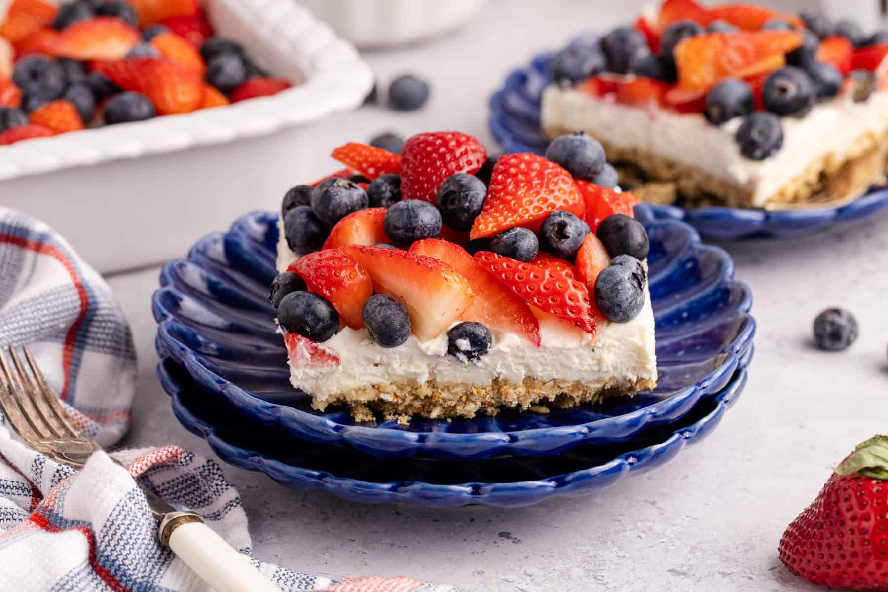 Red, White and Blue Pretzel Salad on a stack of plates