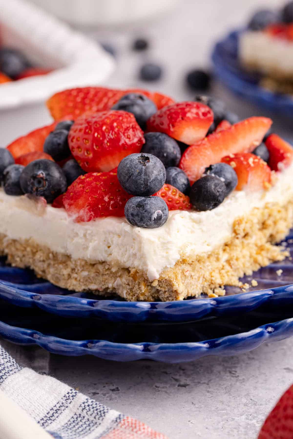 Red, White and Blue Pretzel Salad up close with berries on top