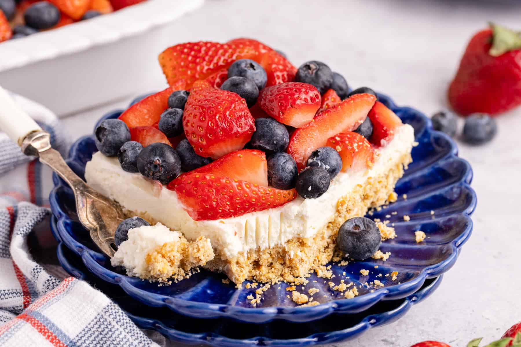 Red, White and Blue Pretzel Salad on a plate with a fork beside