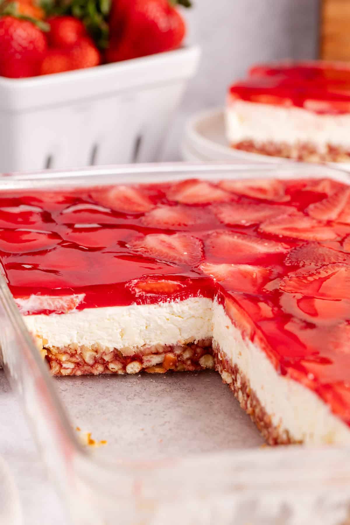 Strawberry Pretzel Salad in a baking dish with a piece taken to see the layers