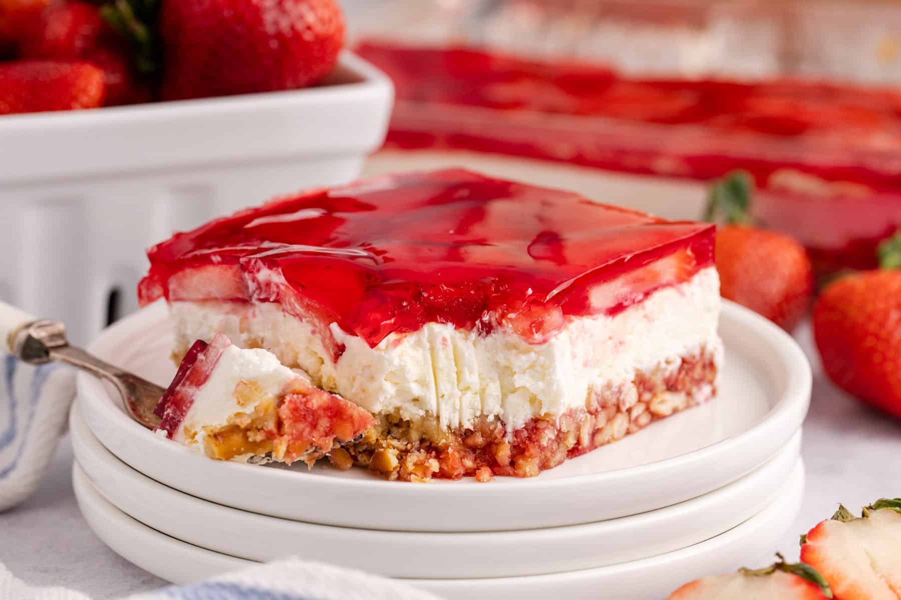 Strawberry Pretzel Salad on a plate with a fork beside