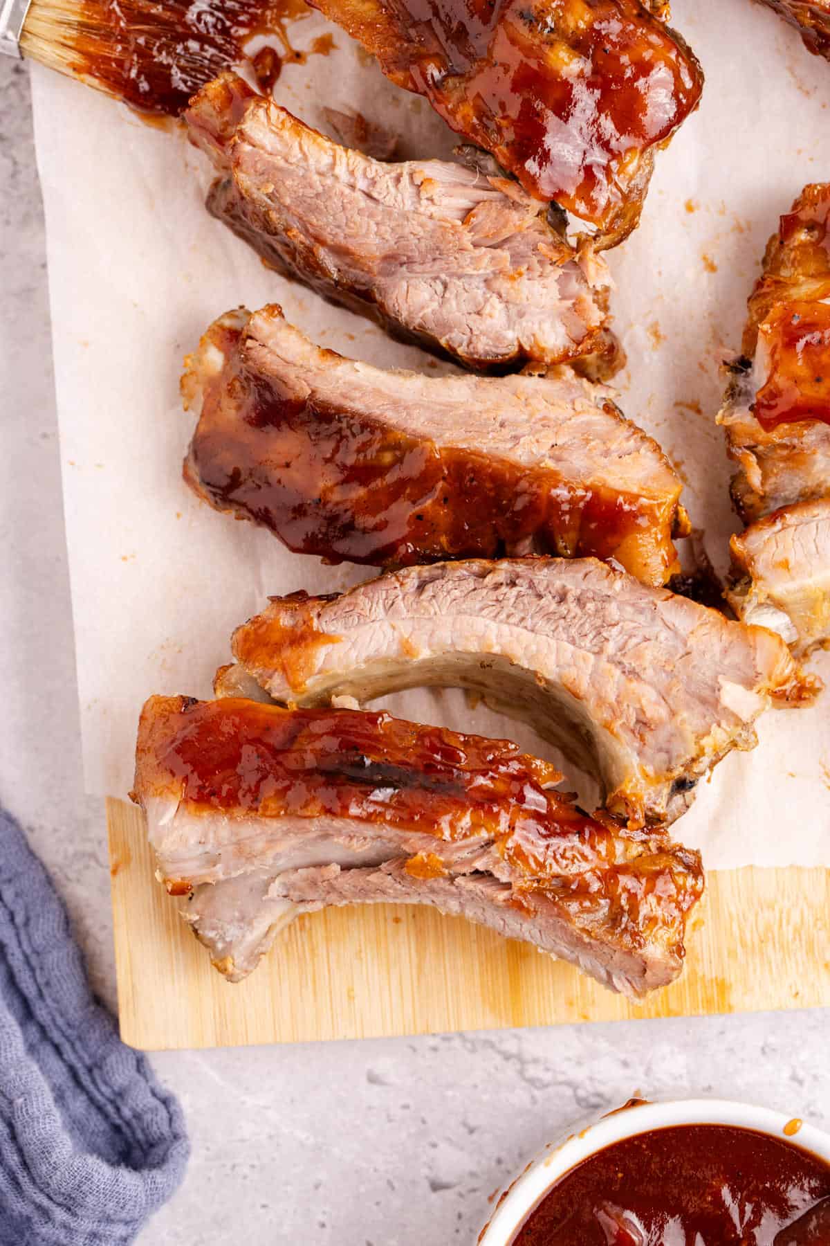BBQ Ribs cut up on a board with bbq sauce