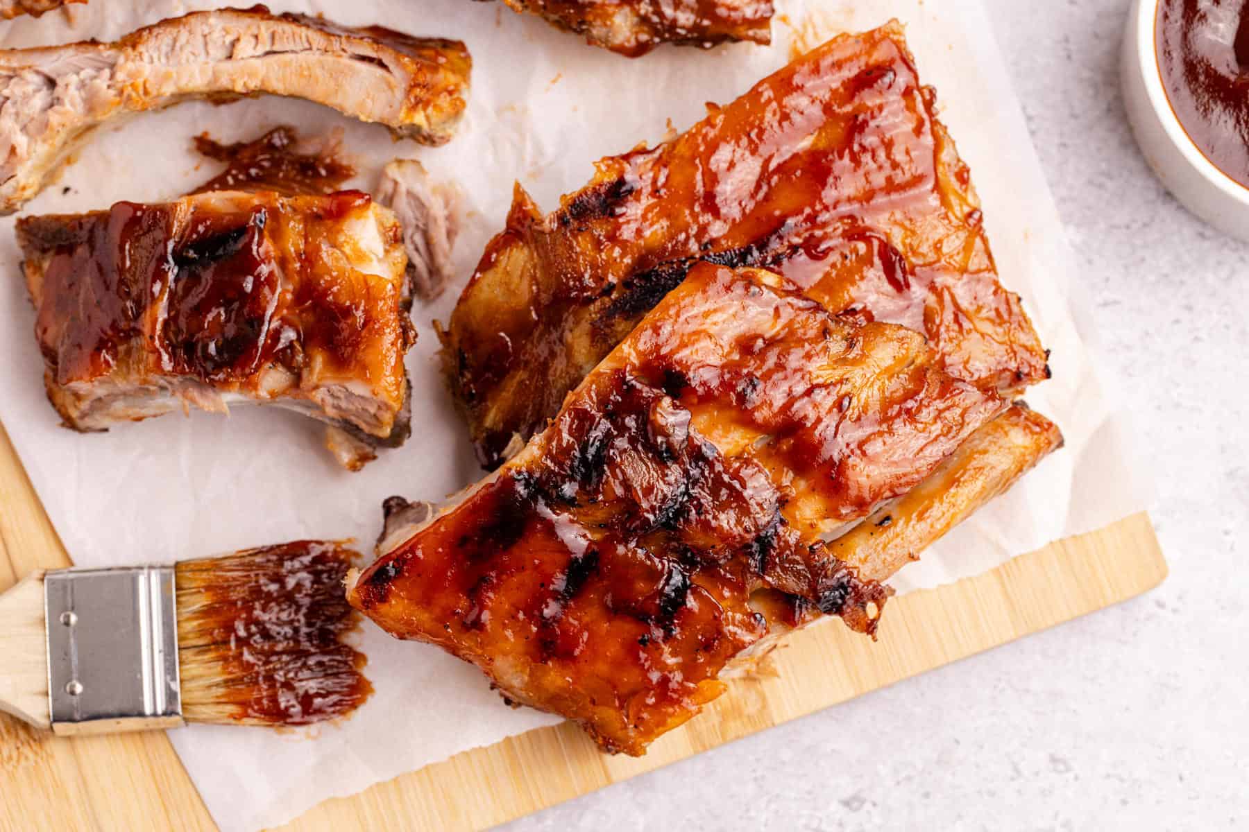 BBQ Ribs on parchment paper with sauce all over