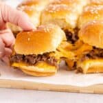 Cheeseburger Sliders with cheese pulling from one to another