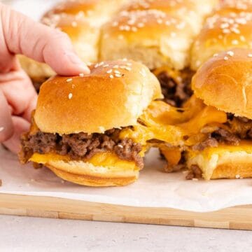 Cheeseburger Sliders with cheese pulling from one to another