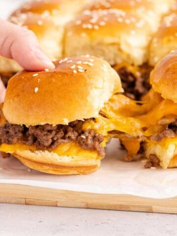 Cheeseburger Sliders with cheese pulling from one to another